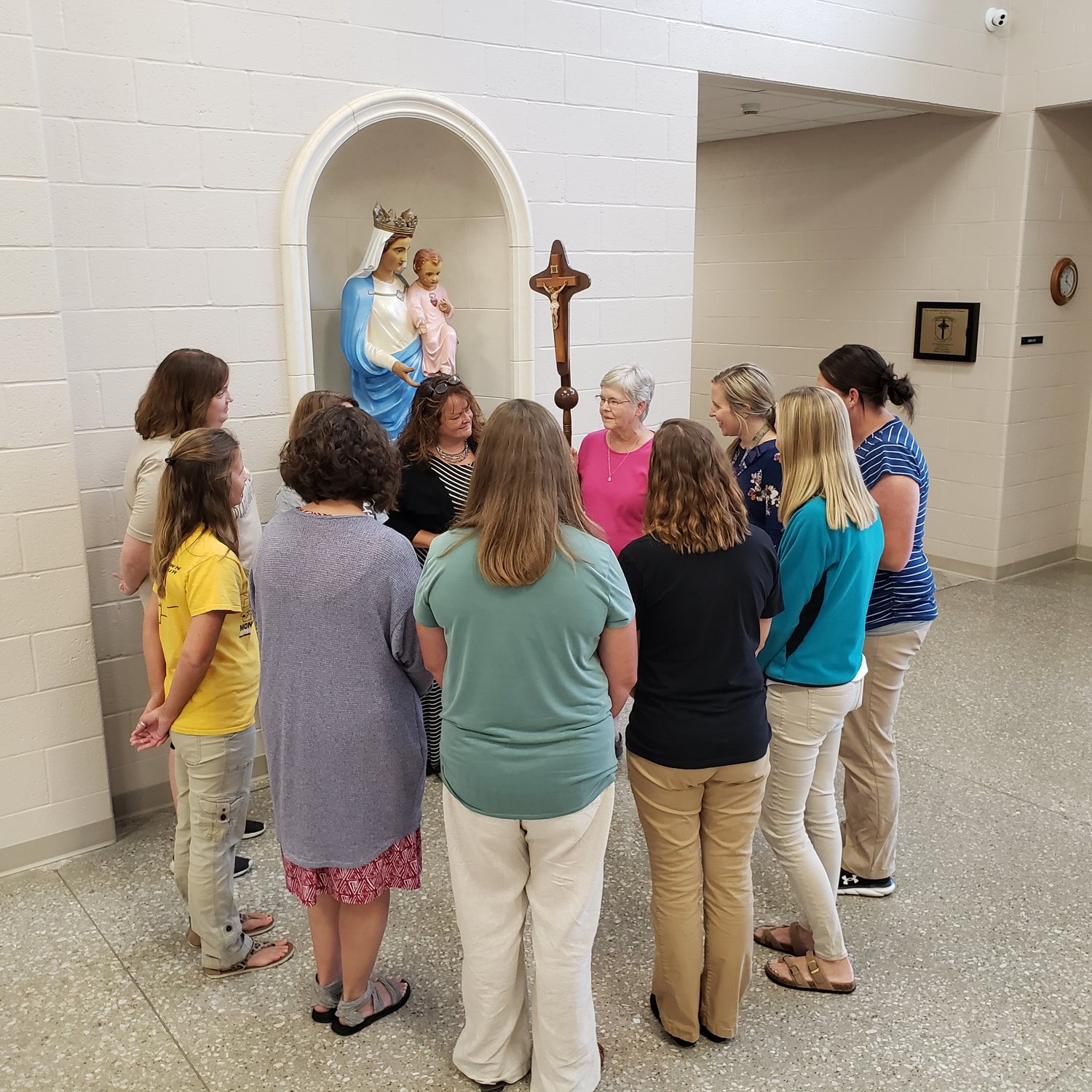 The faculty of Holy Rosary School in Monroe City gathers for prayer in the common area of the school on Sept. 28.